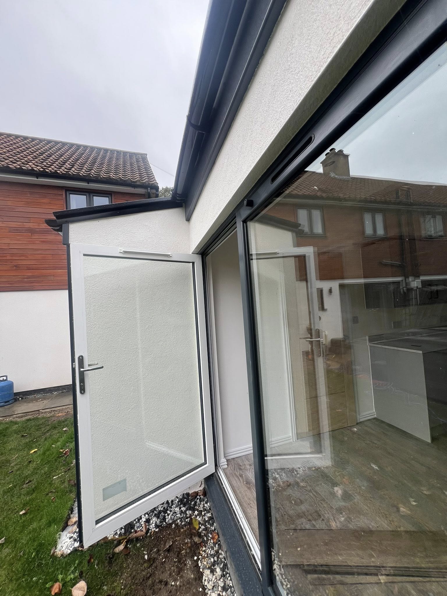 Modern home extension with white render and anthracite framed glazing